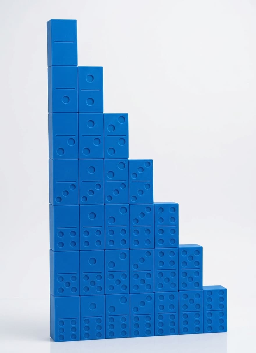 All 28 blue dominoes stacked into a descending staircase seven tiles wide, each tile showing recessed dots and a raised divider line.